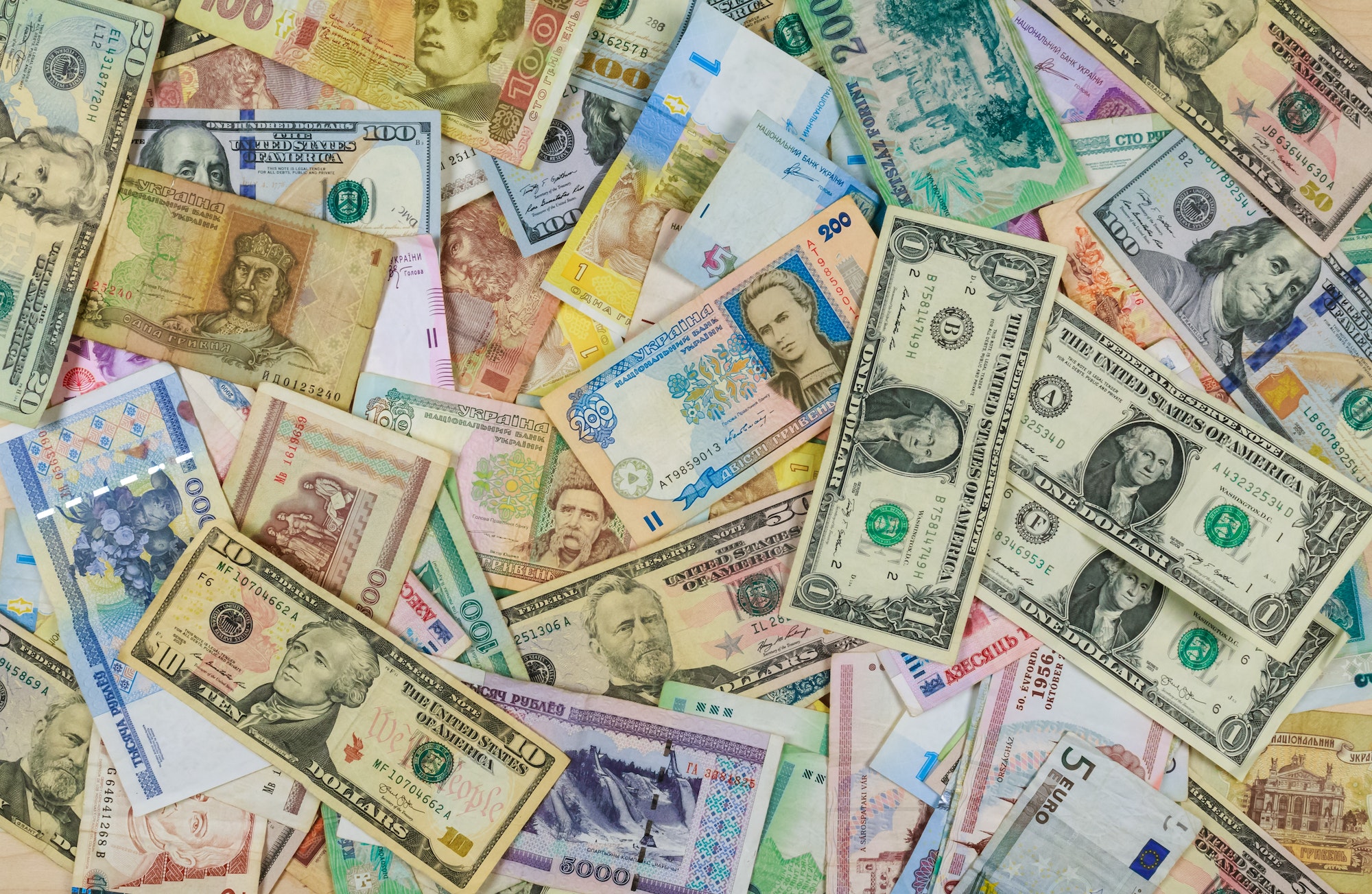 International currencies banknotes from different countries overlapping each other