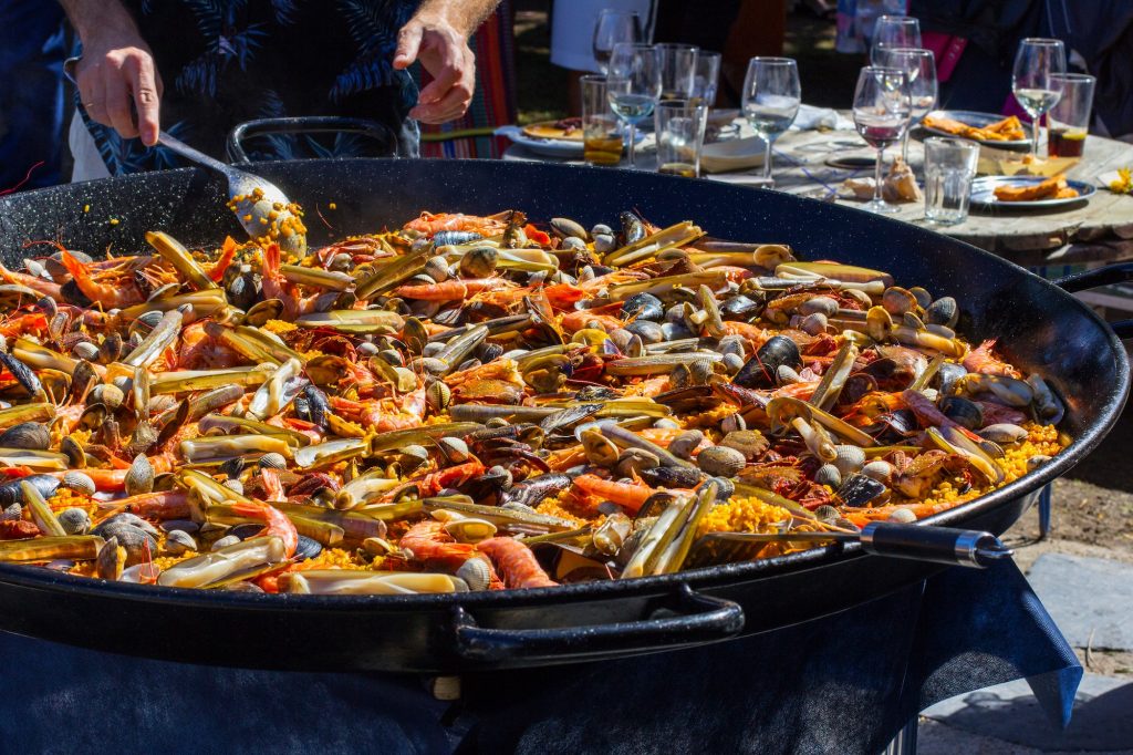 Man cooking a spanish paella, seafood, Spanish food, typical rice