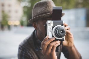 young black man outdoor using camera